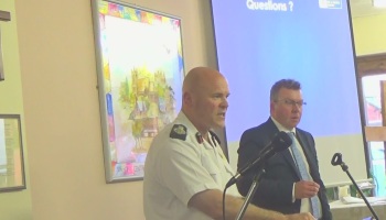 Dan Stephens (Chief Fire Officer, Merseyside Fire and Rescue Service) answers questions at a public consultation meeting in Saughall Massie to discuss proposals for a new fire station (20th April 2015). Kieran Timmins (Deputy Chief Executive) is on the right.